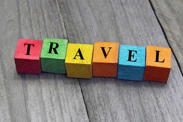 concept of travel word on wooden colorful cubes