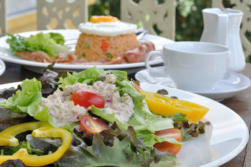 Meal set and tuna salad on wooden table