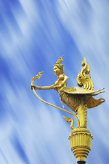 Fototapeta na wymiar Gold Thai KINNAREE on blue blur background.
