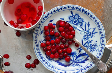 Cranberry tea and berries in saucer on a tray