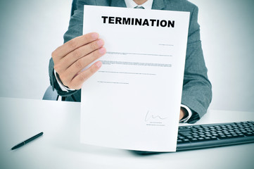 man in suit showing a figured signed termination document