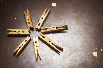Wooden clothespins on a metal plate