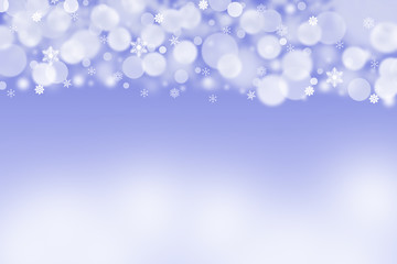 The white blurred balls and snowflakes on a blue background