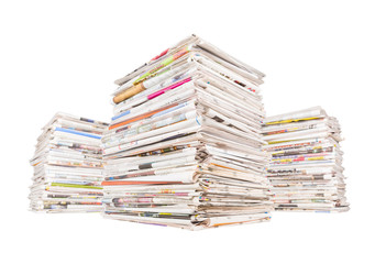 Three big stacks of newspapers