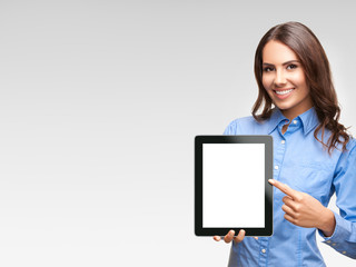 Businesswoman showing blank tablet pc, on grey