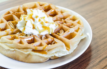 waffles under the caramel topping with cream on top