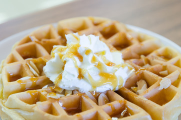 waffles under the caramel topping with cream on top
