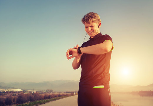 Runner starts his modern stopwatch before jogging