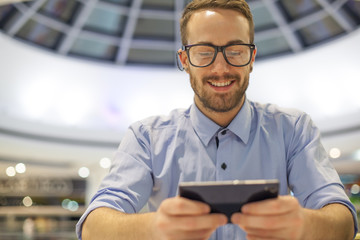 Young Businessman seating on table in restoran and use mobile de