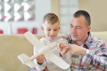 father and son assembling airplane toy