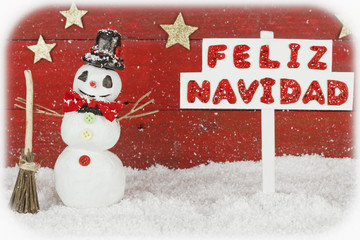A snowman with a Merry Christmas signpost written on spanish