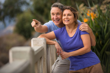 Excited elder couple pointing outside