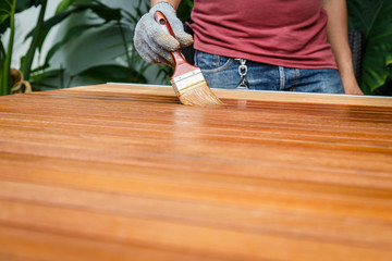 Brush in hand and painting on the wooden table