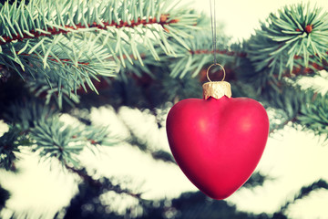 One separated christmas ball handing on a twig.