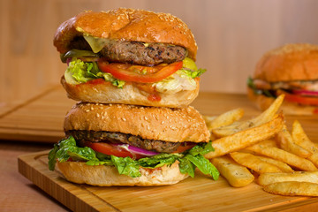 Tasty burgers with melted cheese and thick succulent ground beef