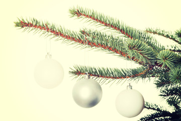 Fototapeta na wymiar Three christmas balls hanging on a twig.
