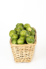 Basket full of brussel sprouts isolated on white
