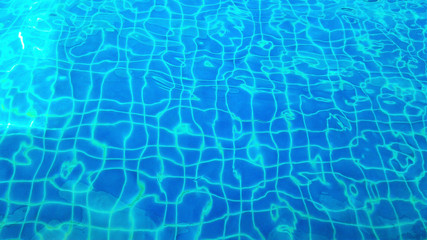water with sun reflections in swim pool