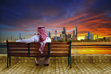 A man looking at the cityscape of kuwait - 73501674