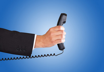 Businessman's Hand Holding Telephone Receiver