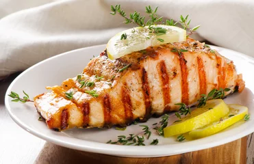 Tuinposter Grilled Salmon with lemon, olives and fresh thyme © bit24