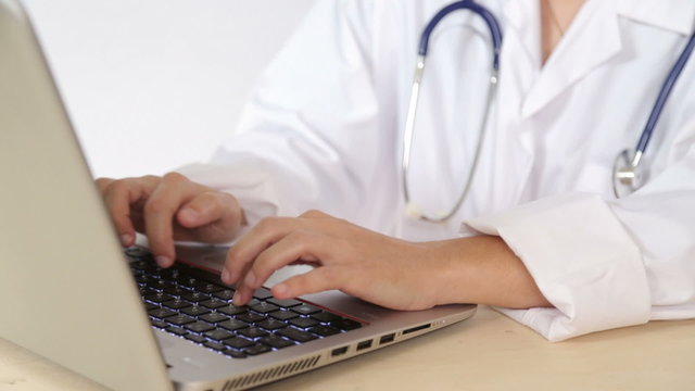 Doctor use laptop computer to perform medical research online