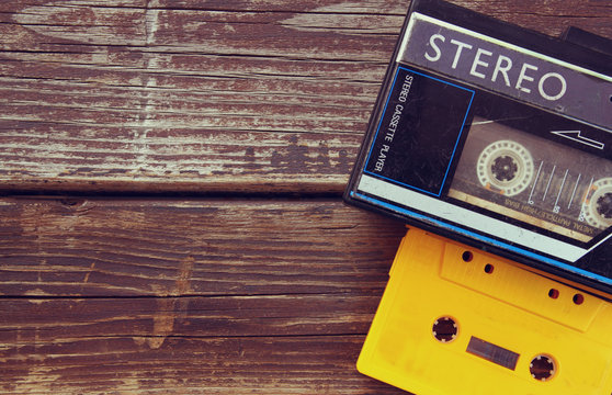 Old portable cassette player on a wooden background. image is in