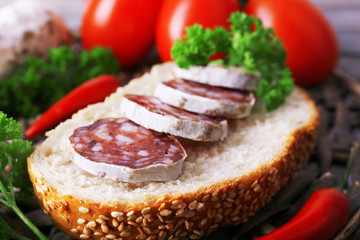 French salami with tomatoes, bread and parsley closeup