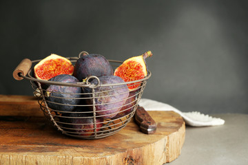 Ripe sweet figs in metal basket,