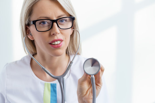Female doctor listening with stethoscope
