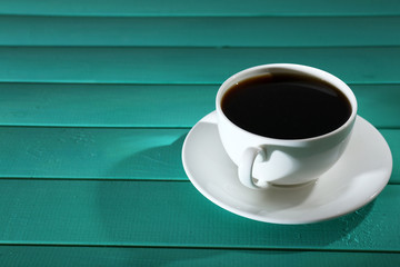 Cup of coffee on wooden table