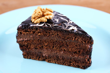 Delicious chocolate cake on plate on table close-up