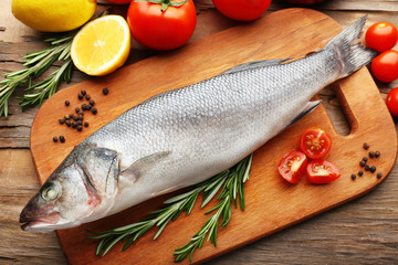 Fresh raw fish and food ingredients on table