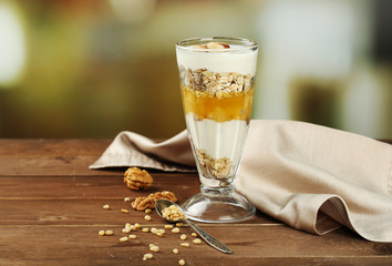 Tasty dessert with oat flakes and honey, on table