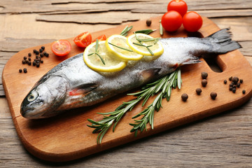 Fresh raw fish and food ingredients on table