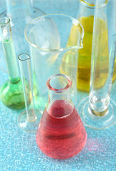 Different laboratory glassware with colorful liquid