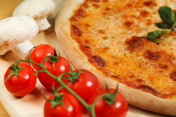 Delicious pizza on wooden plate
