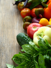 Fresh tomatoes and cucumbers, vegetables on boards