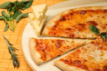 Delicious pizza on wooden plate