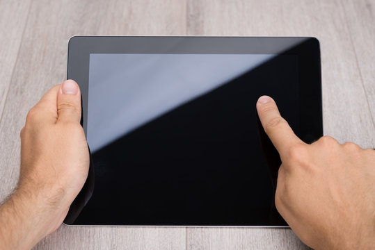 Hands Holding Digital Tablet