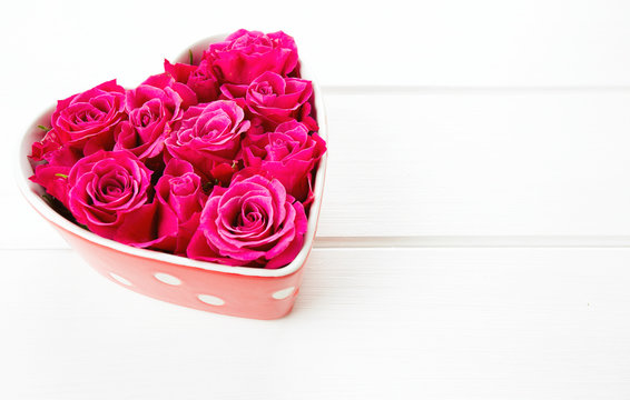 roses in a heart-shaped bowl