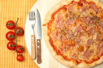 Delicious pizza on wooden plate