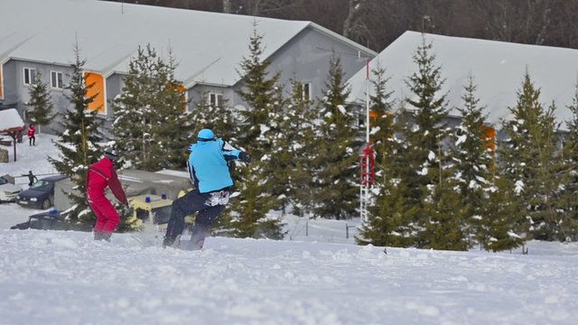 Snowboarder falling on ski slope