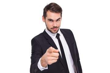 Smart businessman in suit pointing at camera