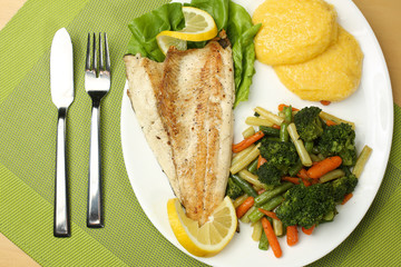 Tasty fish with lemon and vegetables
