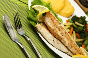 Tasty fish with lemon and vegetables