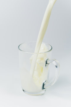 Cup with pouring milk