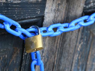 big padlock with a blue chain and  the door closed