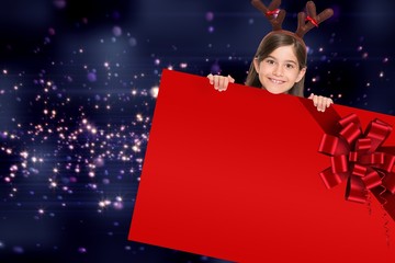 Festive girl showing card with red ribbon