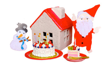 煙突を指さすサンタと赤い屋根の家と雪だるま